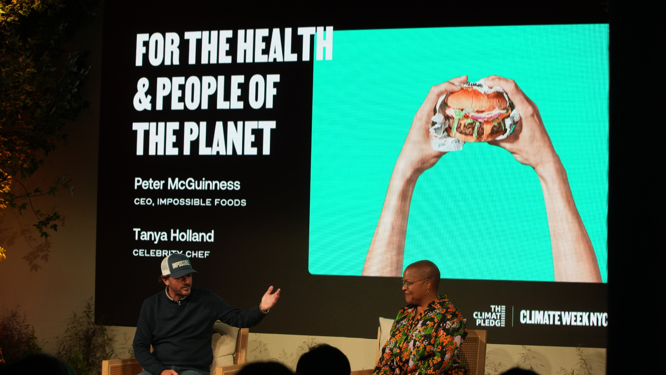 Tanya Holland and Peter McGuinness on stage at The Climate Pledge Summit.