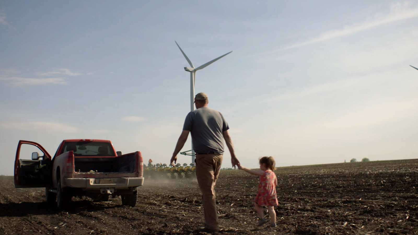 Father and daughter walking in their farm.